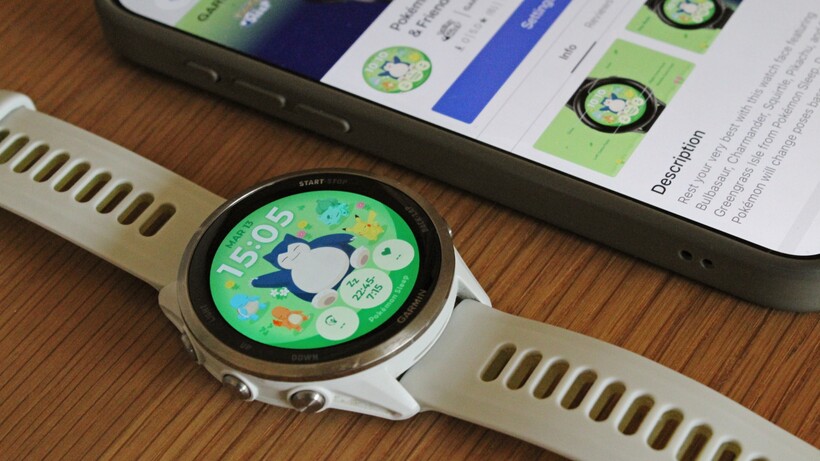 garmin watch showing a pokemon snorlax and friends watch face with the connect iq store on ios in the background
