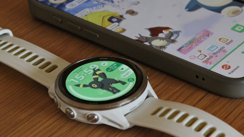 garmin watch showing a pokemon i choose you watch face with the pokemon sleep on ios in the background